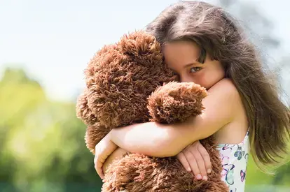 Girl Hugging Teddy Bear