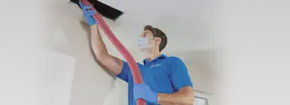 technician cleaning an air duct