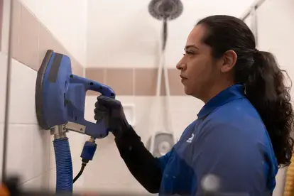 Woman Cleaning Tile